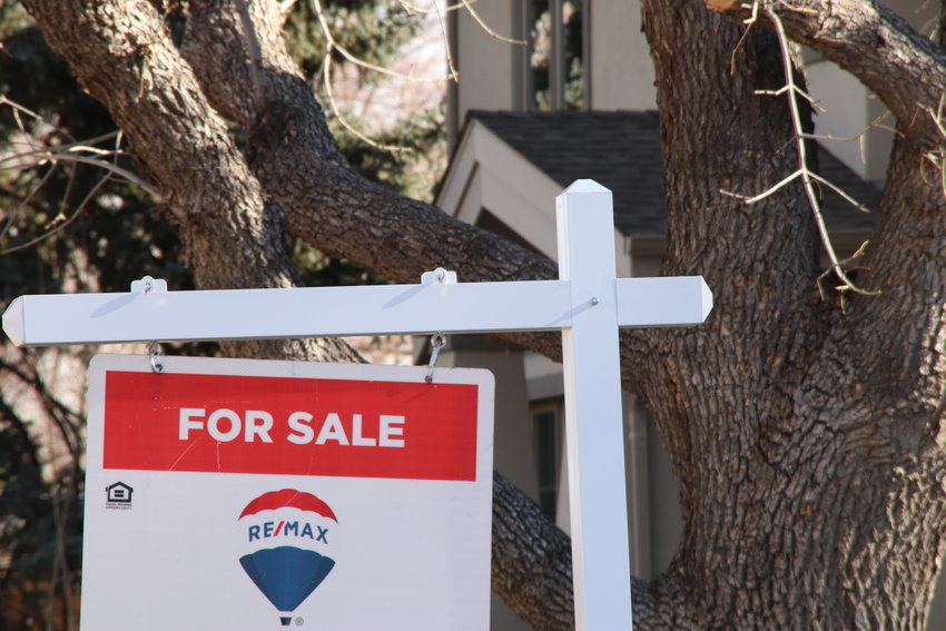 A sign marks a home for sale on Dec. 5 in southeast Denver.